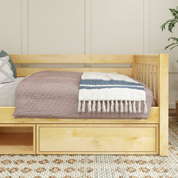 Wooden daybed with storage drawers and cozy bedding, perfect for small spaces.