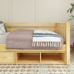 Natural wood daybed with storage drawers, adorned with a cozy blanket and decorative throw pillows, perfect for a modern bedroom.