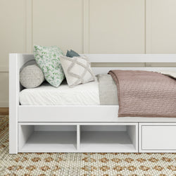 White daybed with cozy pillows and textured blanket in a modern bedroom.