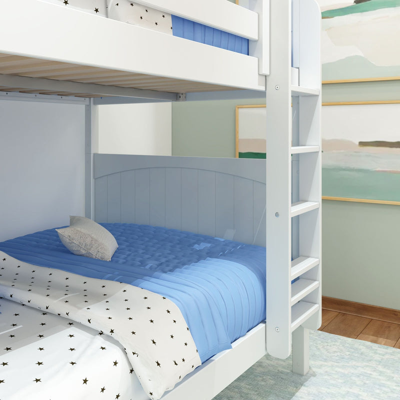 White wooden bunk bed with ladder, blue comforter and star-pattern sheets in modern children's bedroom