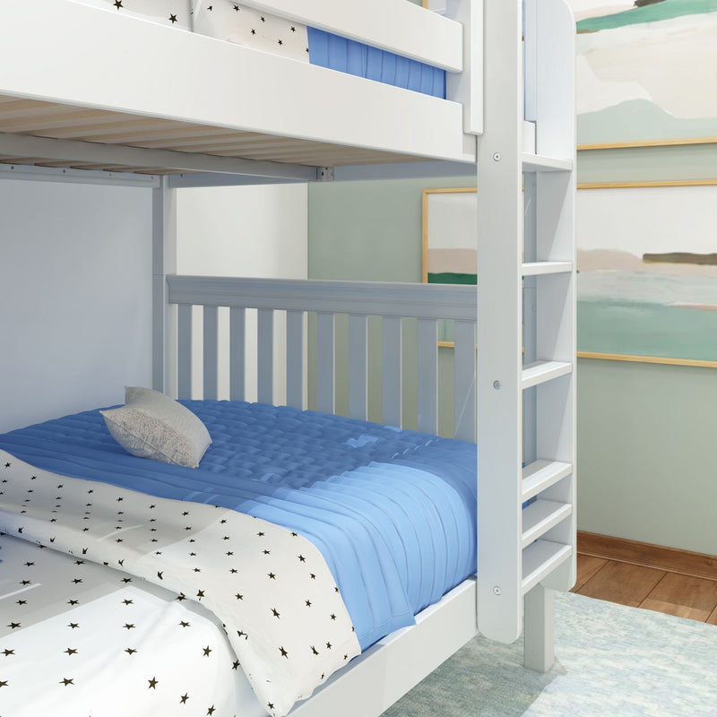 White wooden bunk bed with ladder, blue quilted comforter and star-pattern sheets in a modern children's bedroom, space-saving loft bed