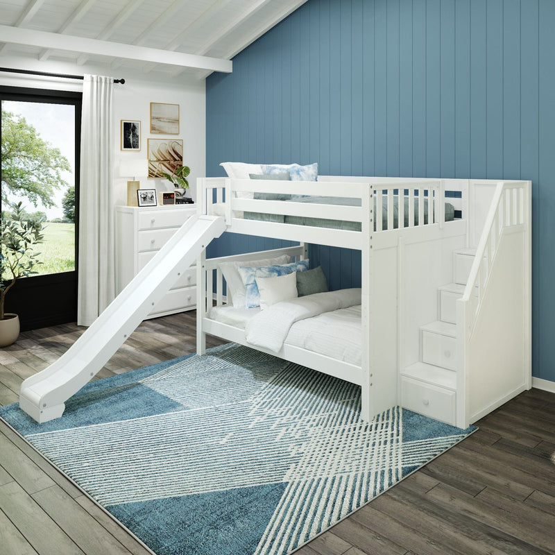 White wooden bunk bed with slide in modern kids' bedroom featuring a blue vertical accent wall, geometric blue rug, white dresser, wall art and large window with natural light