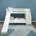White wooden bunk bed with slide and built-in stair storage in a children's bedroom with blue paneled wall, white bedding and blue geometric rug