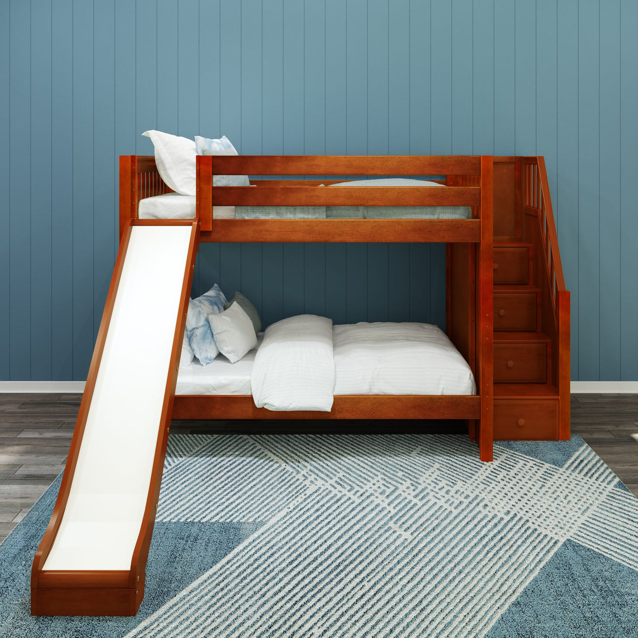 Wooden bunk bed with slide and stairs in a modern bedroom with blue walls and patterned rug.