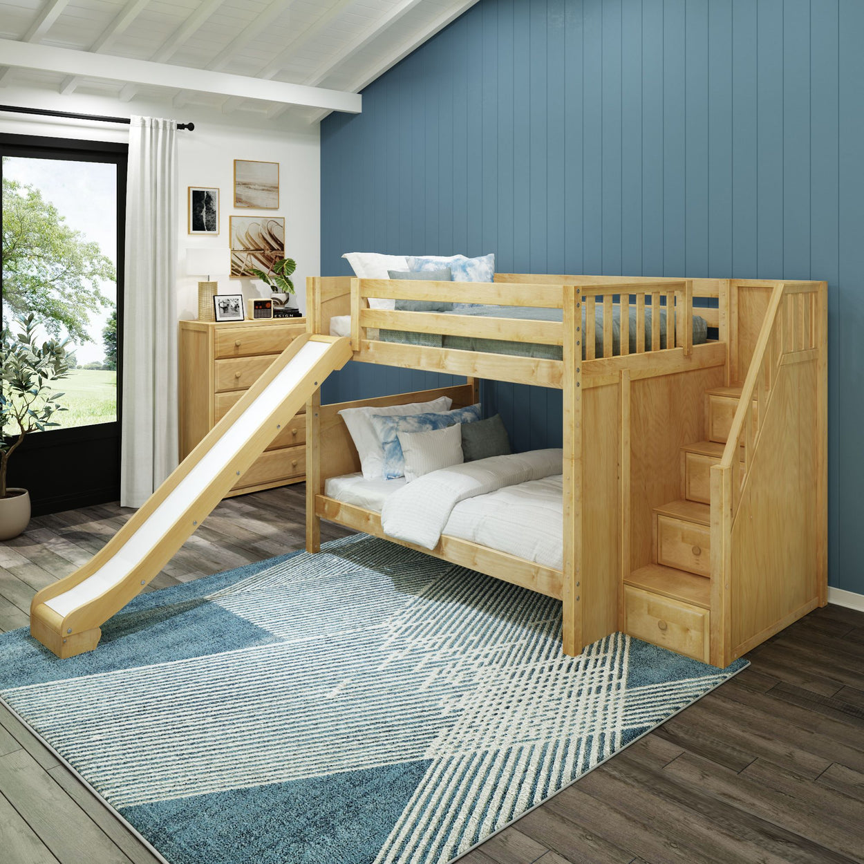 Wooden bunk bed with slide and stairs in a blue-themed children's bedroom.