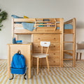 Solid natural wood loft bed with ladder, built-in desk and drawers, top bunk with blue bedding and yellow pillow, bookshelf with children's books, white study chair and blue backpack on yellow striped rug in modern kids bedroom