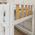 Close-up of a modern white bunk bed safety rail with vertical natural wood slats, neutral bedding and hardwood floor in a bedroom
