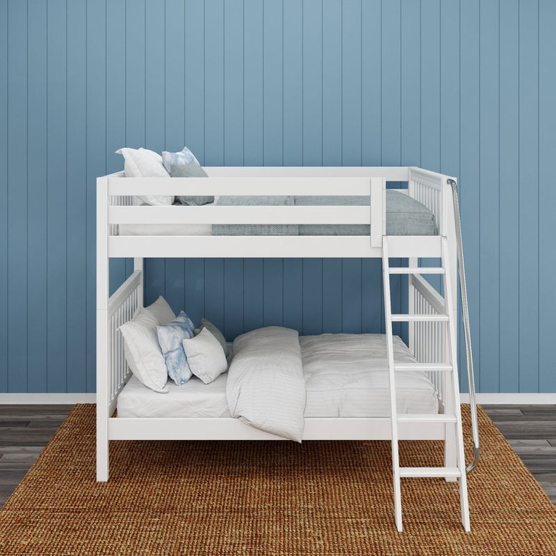 White twin-over-full kids bunk bed with ladder, grey and blue bedding against blue shiplap wall on woven jute rug