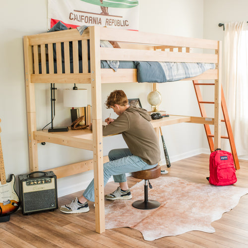 Wooden loft bed with built-in study desk and ladder in teen bedroom, student studying with lamp, globe, guitar amp and red backpack
