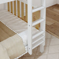 Close-up of white wooden bunk bed ladder with natural wood slats, beige textured bedding and hardwood floor in children's bedroom