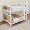 Modern white wooden bunk bed with natural wood slats and ladder, beige pom-pom pillows and neutral nursery decor against patterned wallpaper