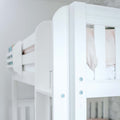 Close-up of white wooden bunk bed safety rail and slats with visible screws and soft pink bedding in a modern nursery