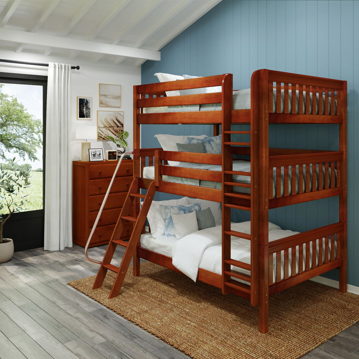 Three-tier wooden bunk bed in a bright bedroom with blue walls and modern decor.