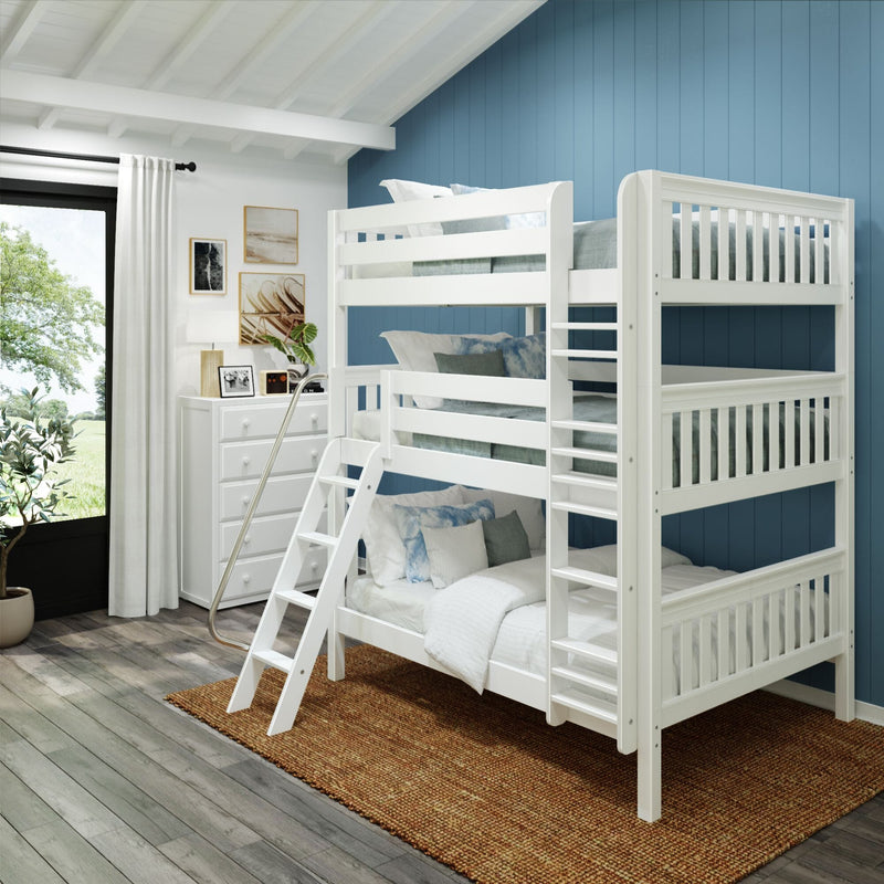 White wooden bunk bed with ladder in bright kids bedroom with blue accent wall, dresser, woven rug and window view