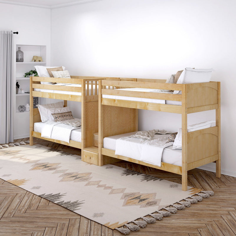 Natural wood twin-over-twin bunk beds with under-bed storage in a bright modern kids' bedroom featuring white bedding, neutral patterned rug, built-in shelving and decorative pillows