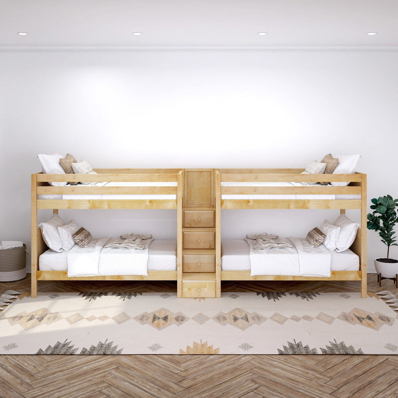 Natural wood twin bunk beds with built‑in ladder and storage drawers, white bedding and neutral pillows on a patterned rug beside a potted plant in a minimalist kids' bedroom