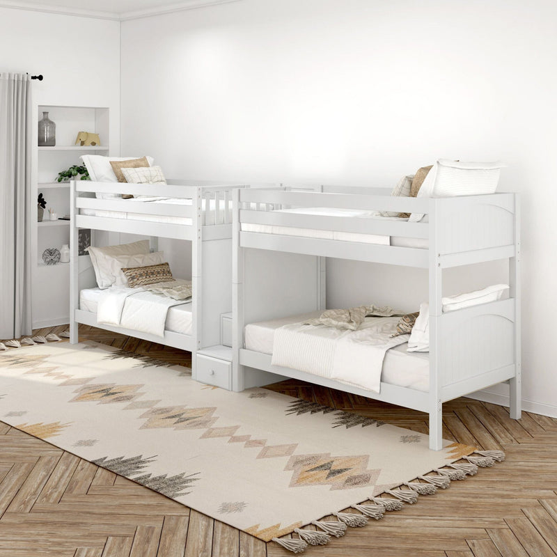 Bright Scandinavian kids' bedroom with white twin bunk beds, neutral bedding, patterned area rug and wood parquet floor