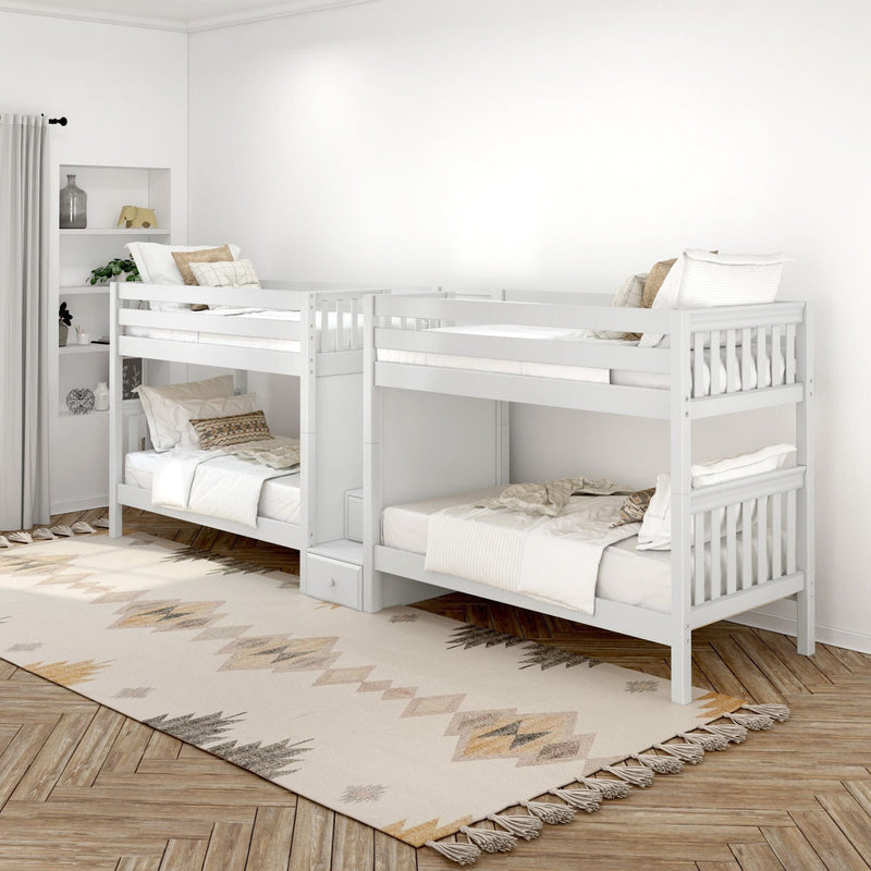 Modern minimalist kids bedroom with white twin-over-twin bunk beds, neutral boho rug, textured pillows, built-in shelves and herringbone wood floor