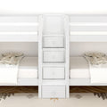 White twin bunk beds with built-in center storage drawers and ladder, neutral plaid bedding in modern kids' bedroom