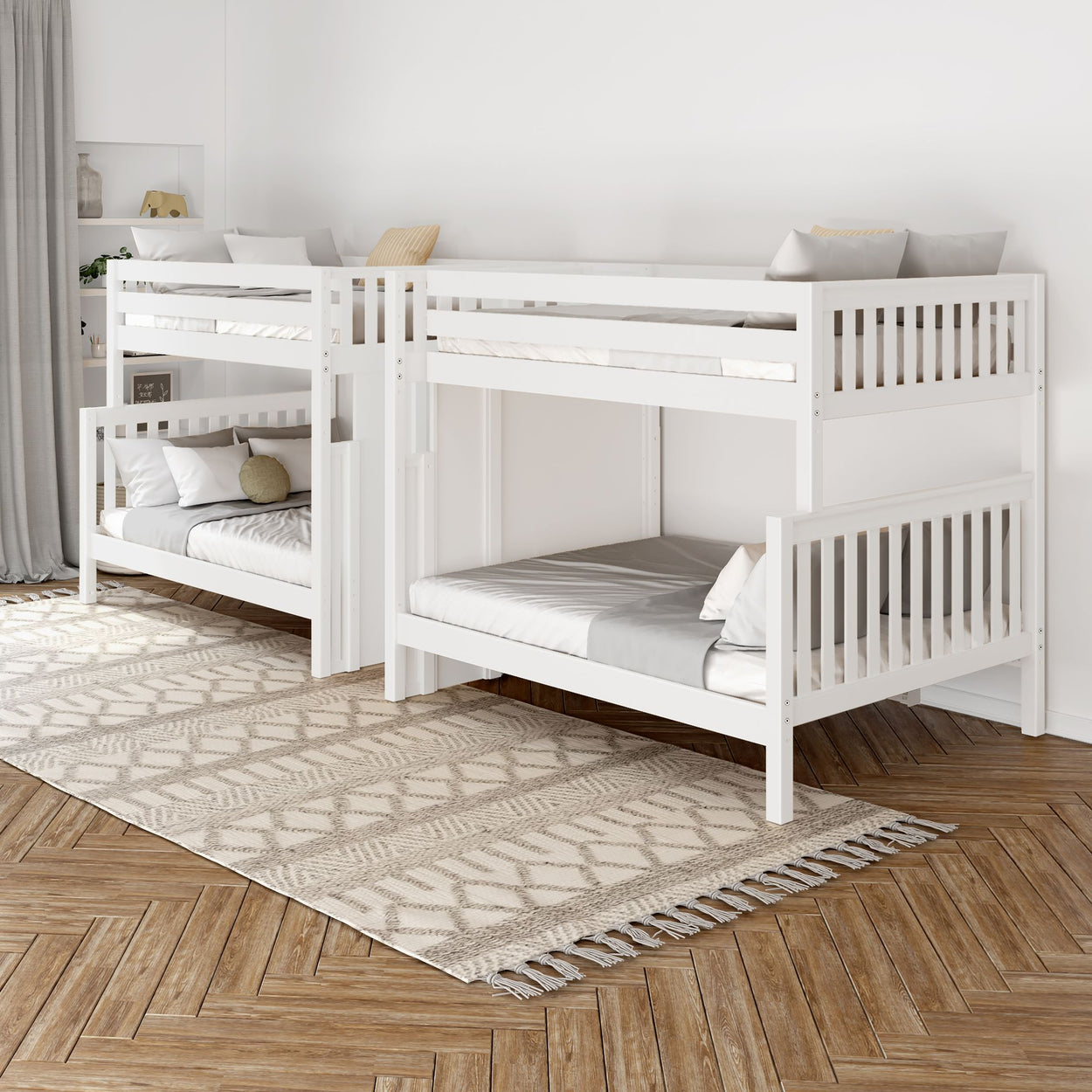 White wooden bunk beds in a modern bedroom with herringbone wood flooring and beige patterned rug.