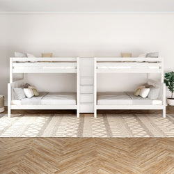 White wooden quadruple bunk bed with minimalist bedding in a modern bedroom with wooden flooring and natural light.