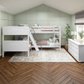 White wooden bunk beds in kids' bedroom with pale green paneled accent wall, herringbone hardwood floor, area rug, dresser and natural light