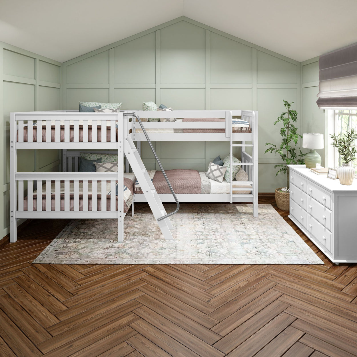 Modern white triple bunk bed with ladder in a spacious bedroom featuring light green paneled walls, cozy bedding, wooden herringbone floor, and a white dresser.