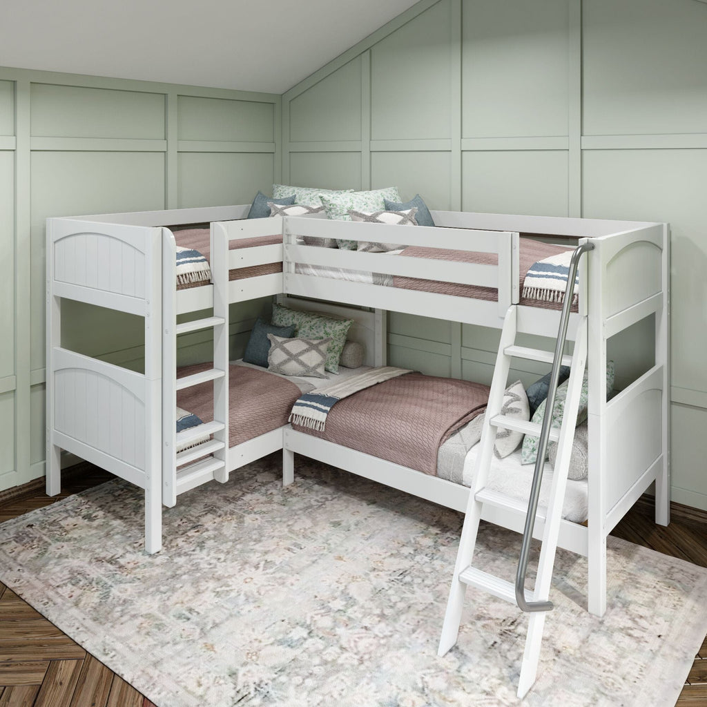 White L-shaped wooden twin bunk bed with ladder in mint-green paneled kids' bedroom, modern farmhouse corner bunk setup with blush quilts, decorative pillows and patterned area rug