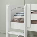 Close-up of a white wooden bunk bed ladder and safety rail with a striped fringed blanket on the top mattress in a modern kids' bedroom