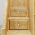 Close-up of light maple wood built-in drawers with round knobs in under-stair storage cabinet