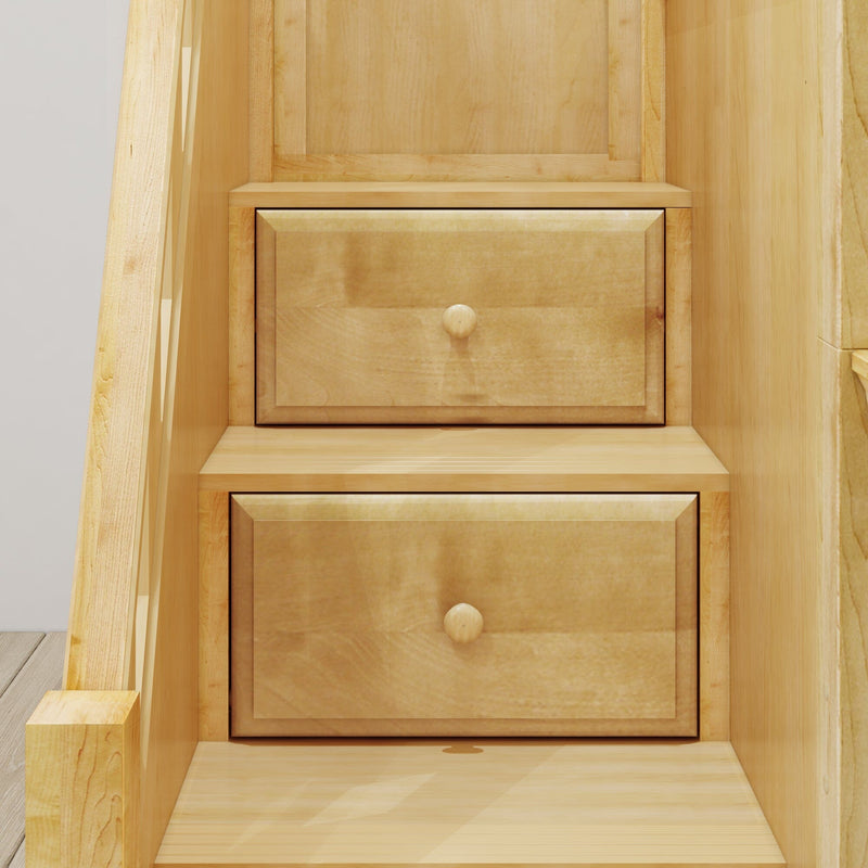 Close-up of light maple wood built-in drawers with round knobs in under-stair storage cabinet