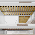 Modern white metal bunk bed underside with wooden mattress slats, ladder and beige bedding in a bright minimalist bedroom