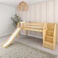 Natural wood kids loft bed with slide and storage stairs in a neutral beige nursery with rattan pendant light and potted plant
