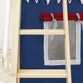 Close-up of wooden ladder rungs against a navy blue children’s play tent with red trim, white tie straps and mesh window on a beige rug