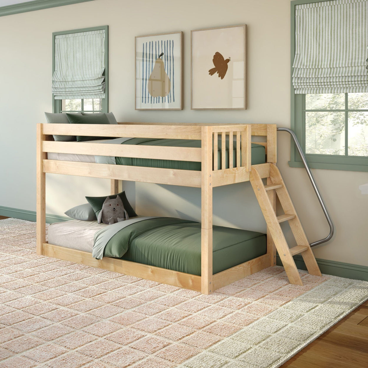 Light natural wood twin-over-twin bunk bed with ladder, green bedding and plush pillow in a bright children's bedroom with striped Roman shades and framed wall art