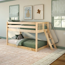 Light natural wood twin-over-twin bunk bed with ladder, green bedding and plush pillow in a bright children's bedroom with striped Roman shades and framed wall art