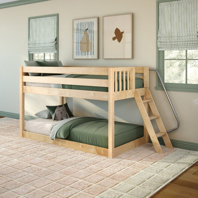 Children's wooden bunk bed with ladder and metal handrail, green bedding, striped Roman shades, framed pear and bird art and plush toy in cozy kids' bedroom.