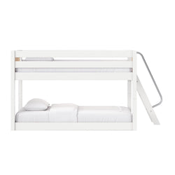 White modern wooden bunk bed with angled metal ladder, minimalist space-saving design and white mattress and pillows