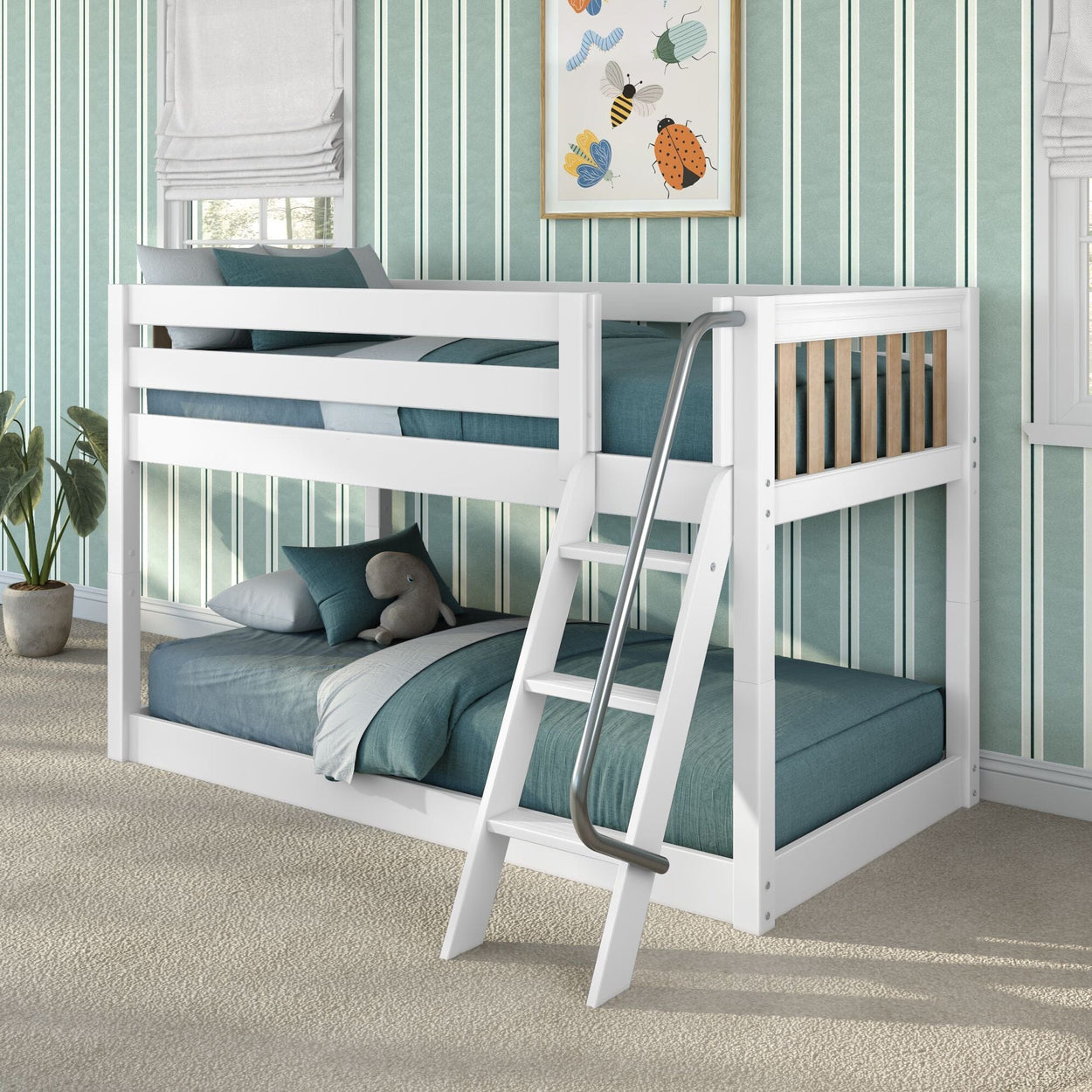 White wooden kids' bunk bed with angled metal handrail ladder, teal bedding, striped wallpaper and plush toy in children's bedroom