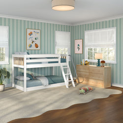 Kids bedroom with white bunk bed and ladder, green striped wallpaper, natural wood dresser, table lamp, wavy rug and plush caterpillar toy
