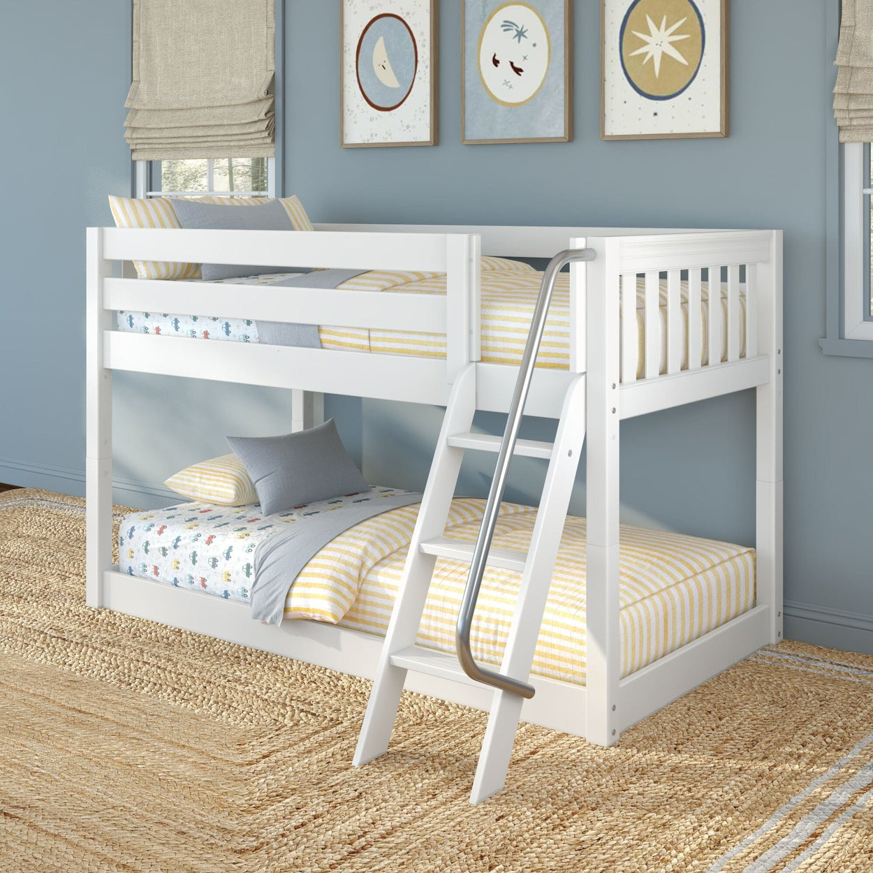 White wooden twin-over-full bunk bed with angled ladder in a coastal-style kids' bedroom, yellow-striped bedding and blue walls