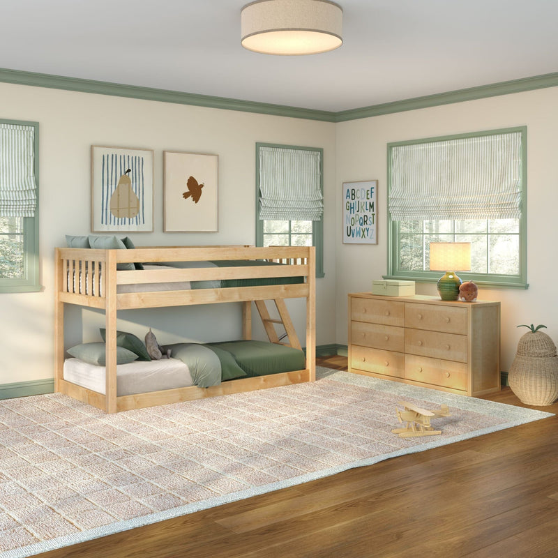 Cozy kids' bedroom with light wood bunk bed, green bedding, pale green window trim and Roman shades, wooden dresser with lamp and alphabet wall art