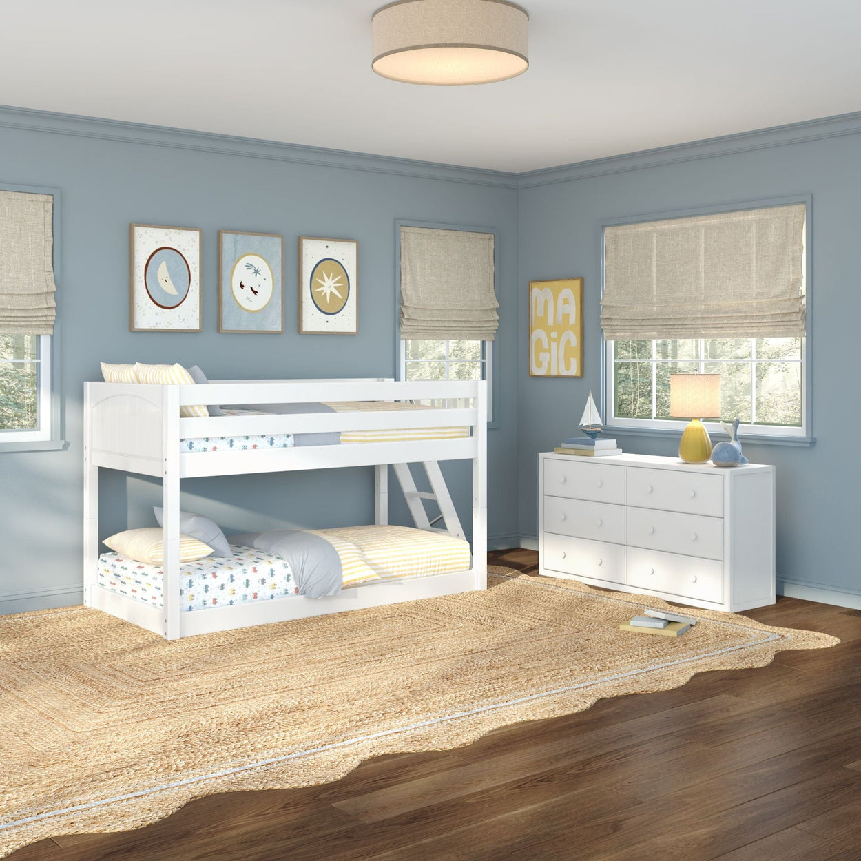 Bright kids' bedroom with white twin-over-twin bunk bed, light blue walls, white dresser, natural jute rug, hardwood floors and children's coastal decor