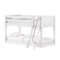 White wooden bunk bed with ladder and top guardrail, two mattresses and pillows for kids' bedroom, modern space-saving design