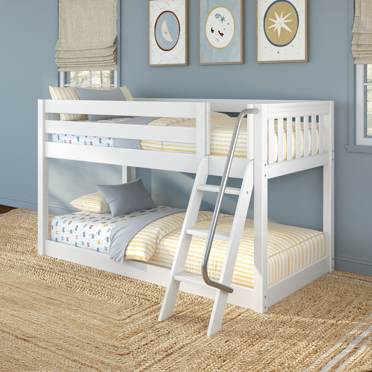 White wooden twin-over-full bunk bed with angled metal-handled ladder in a blue children's bedroom, yellow-striped bedding and nautical wall art