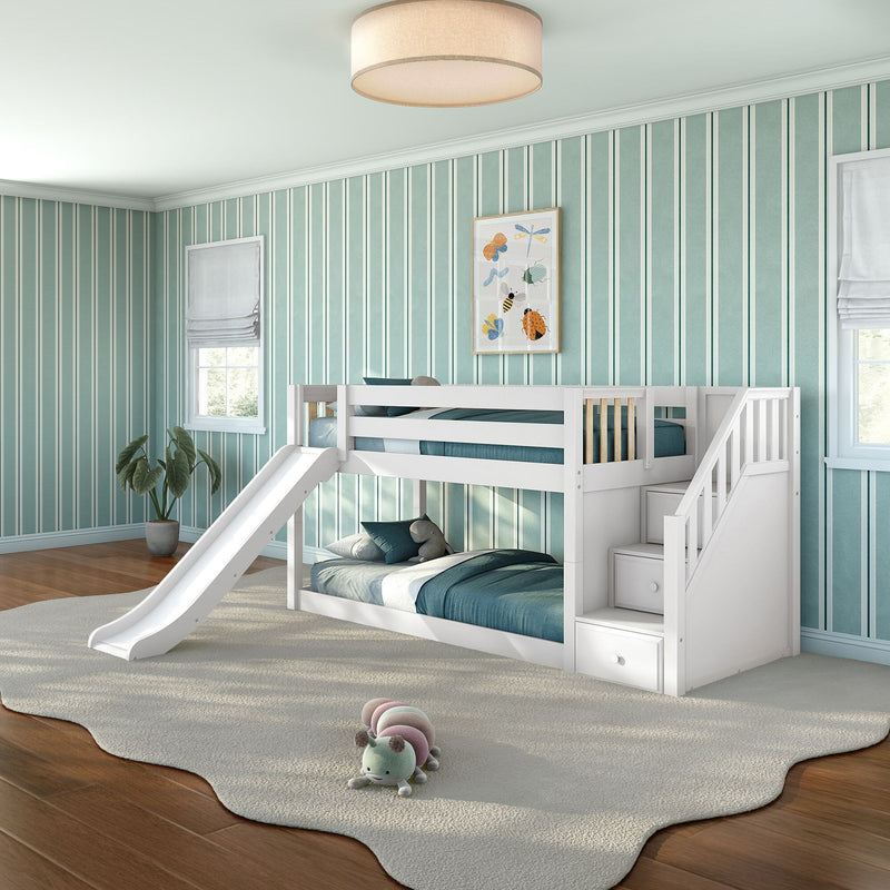 White kids bunk bed with slide and stairs in teal striped children's bedroom, framed insect art, plush caterpillar toy and cozy bedding