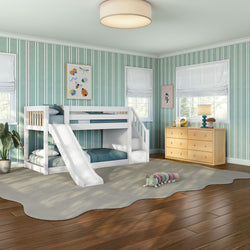 Modern kids bedroom with white bunk bed and slide, teal striped wallpaper, natural wood dresser, hardwood floors, soft area rug and plush caterpillar toy