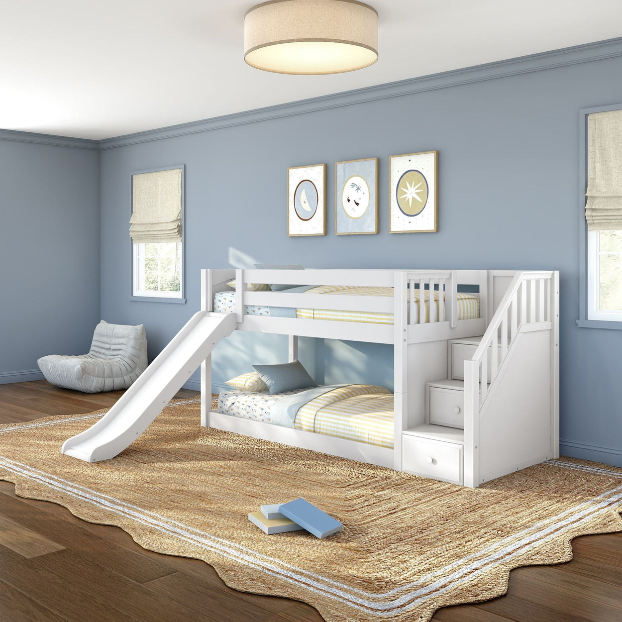 White twin bunk bed with slide and built-in storage stairs in a light-blue children's bedroom with coastal wall art and woven jute rug