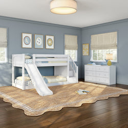 White bunk bed with slide in a blue children's bedroom with white dresser, natural jute rug on hardwood floors and nautical wall art