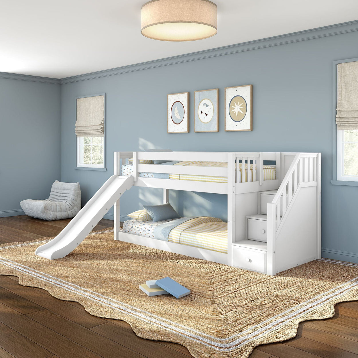 White twin bunk bed with slide and stair storage drawers in a modern blue-walled kids' bedroom with striped bedding, natural jute rug and hardwood floors
